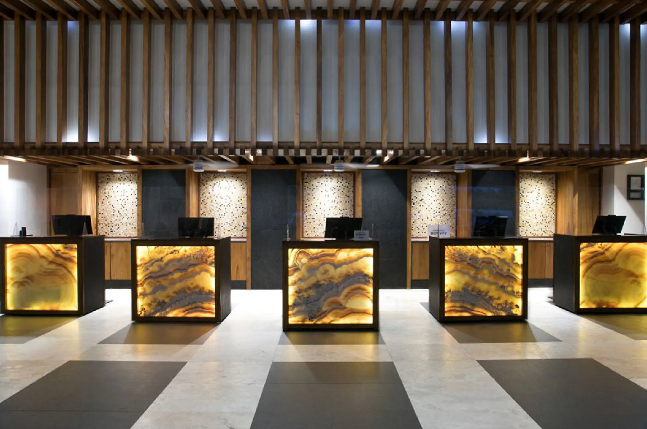 Modern front desk lobby with glowing stone panels at Marriott Puerto Vallarta, Puerto Vallarta