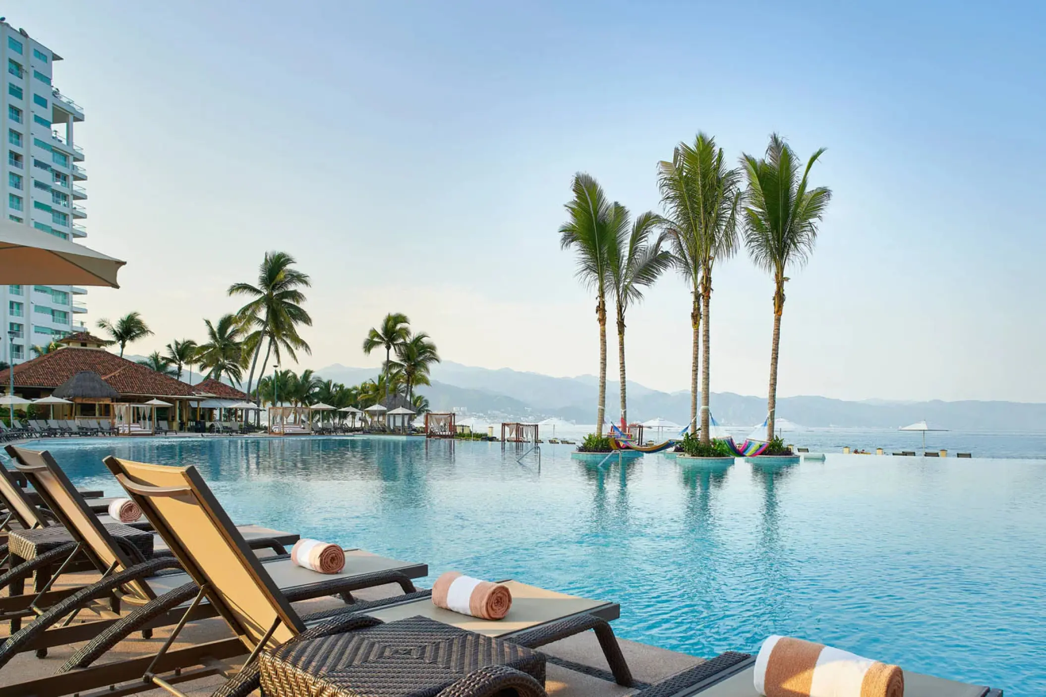 Marriott Puerto Vallarta infinity pool with lounge chairs and palm trees, Puerto Vallarta