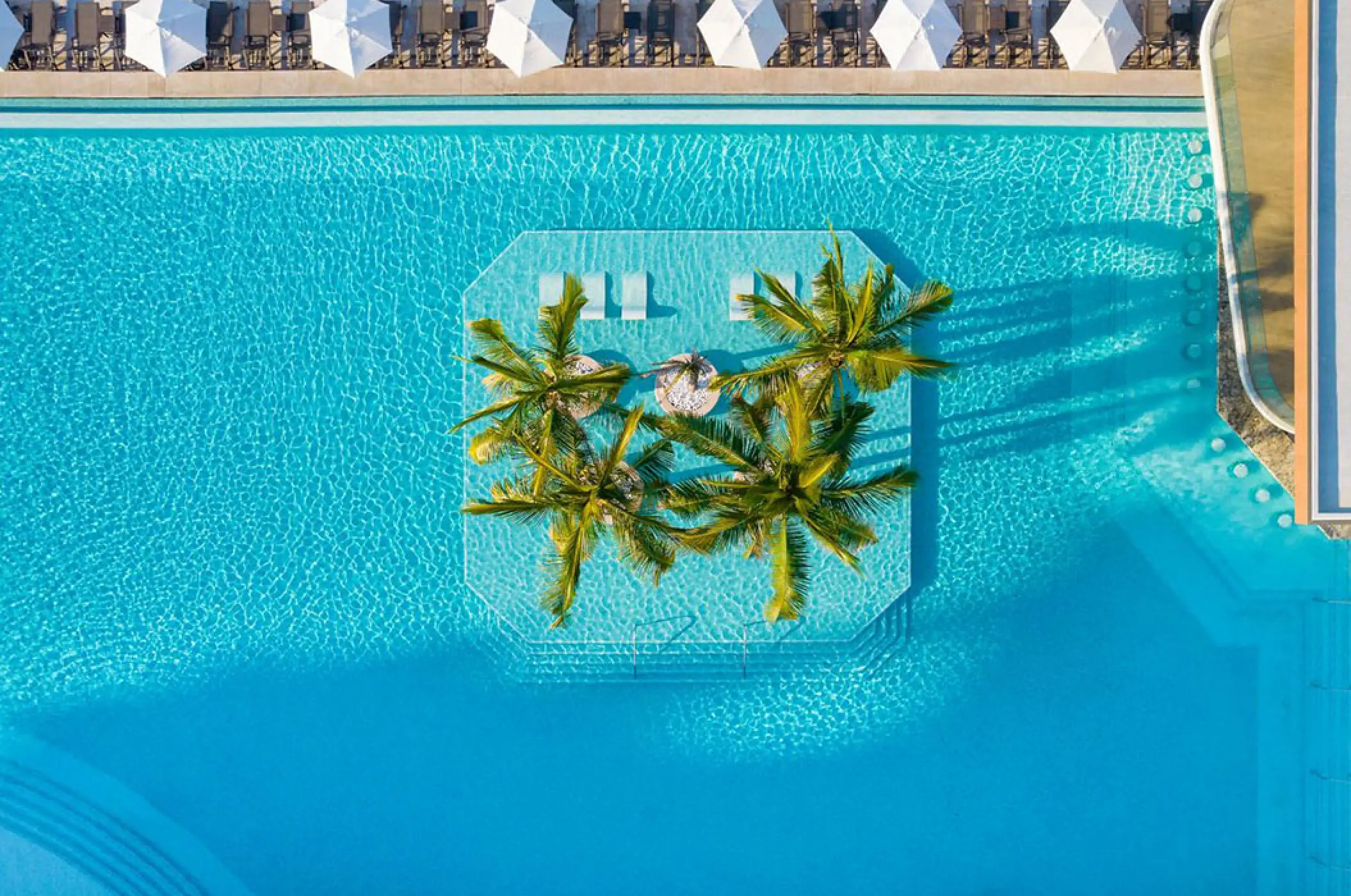 Overhead drone view of the swimming pool and palm tree island at Marriott Puerto Vallarta, Puerto Vallarta