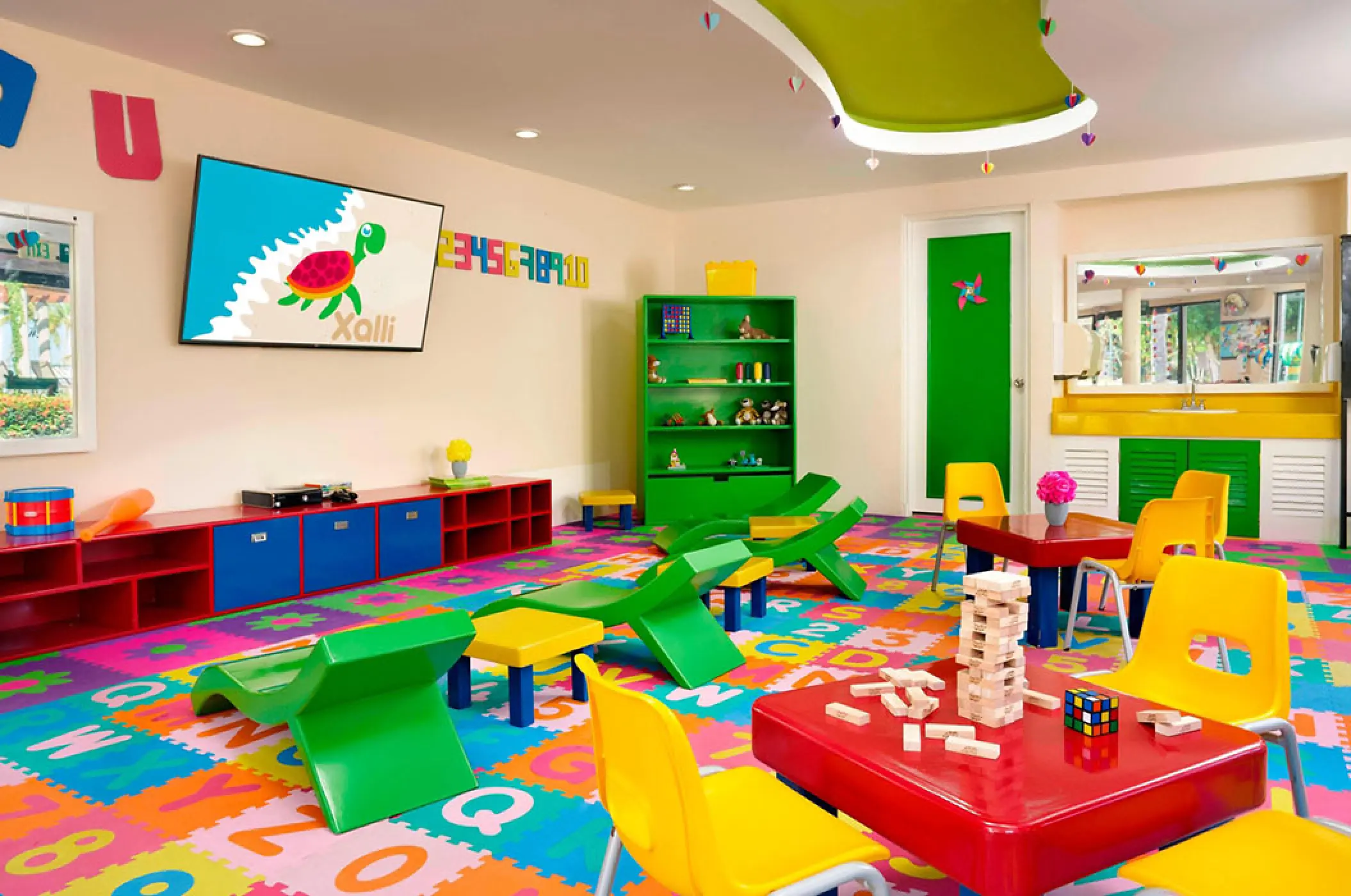 Colorful kids club play area with games and a TV at Marriott Puerto Vallarta, Puerto Vallarta