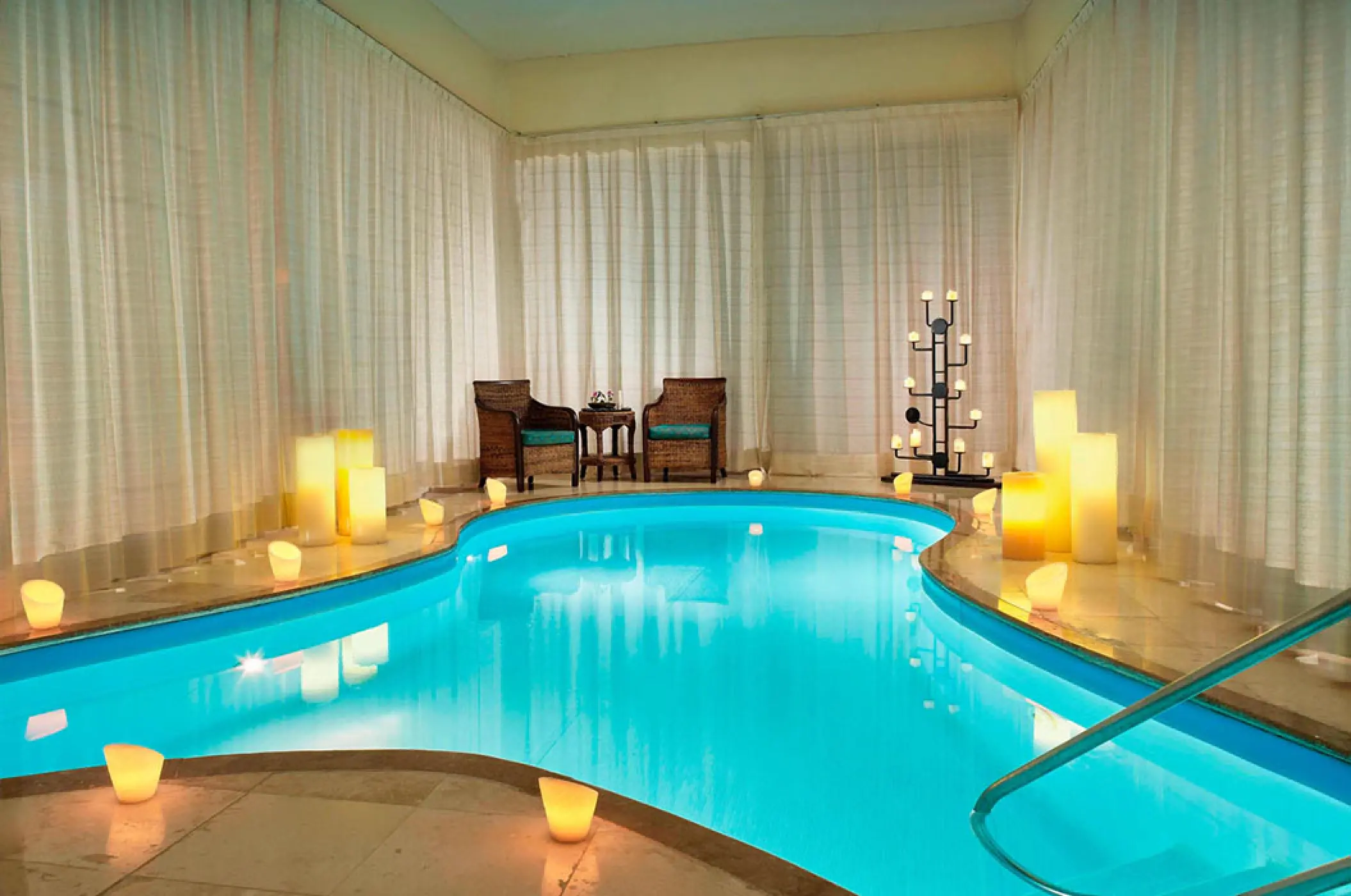 Indoor spa pool with candles and white curtains at Marriott Puerto Vallarta, Puerto Vallarta