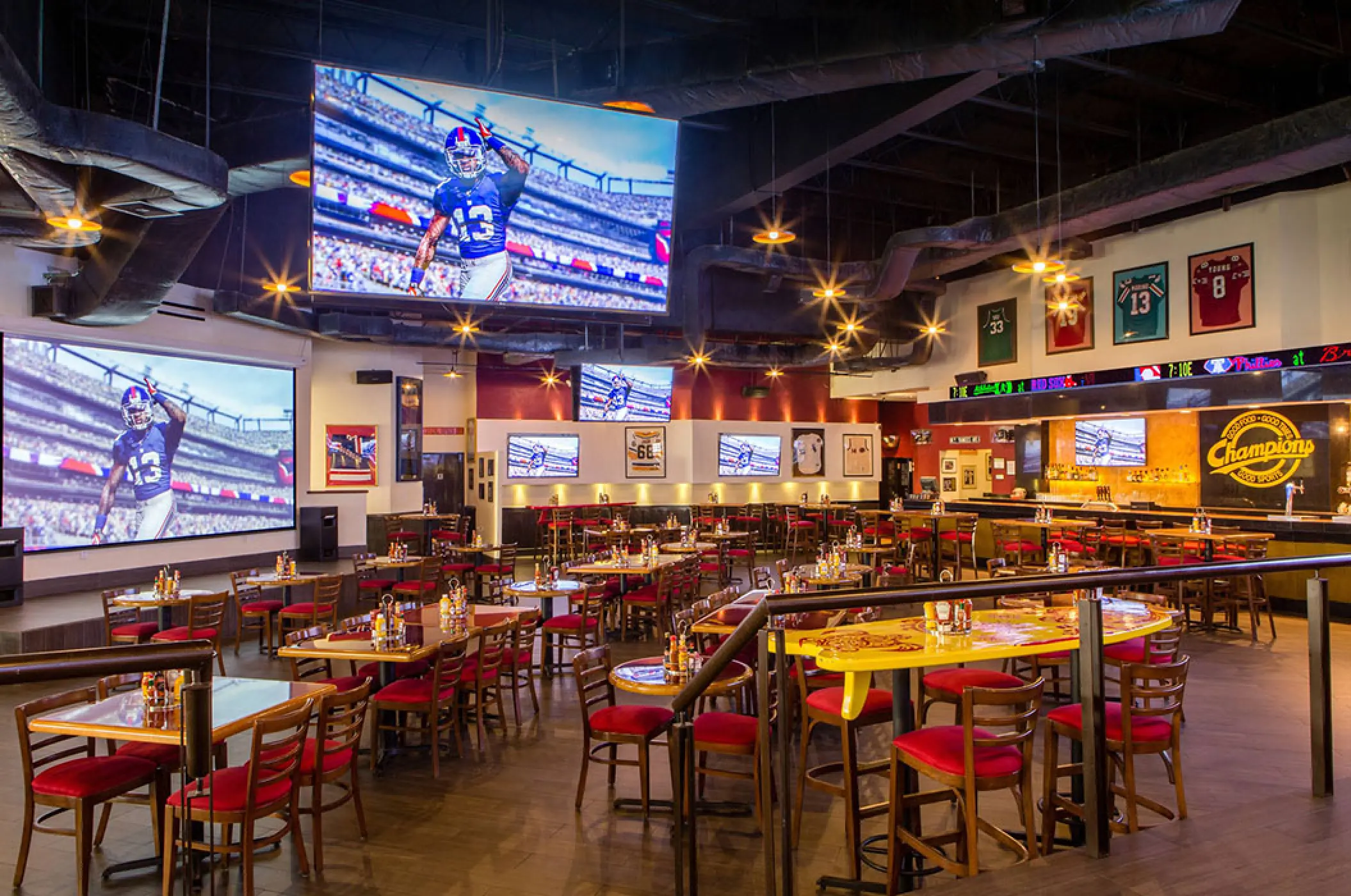Champions Sports Bar with large screens and red seating at Marriott Puerto Vallarta, Puerto Vallarta