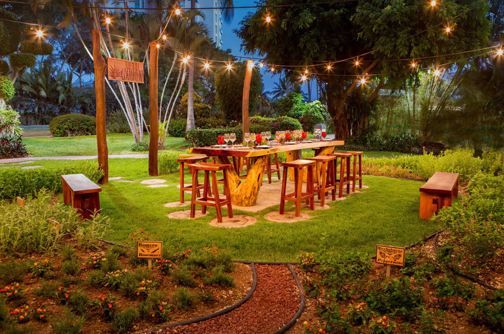 Outdoor herb garden dining table with string lights at Marriott Puerto Vallarta, Puerto Vallarta