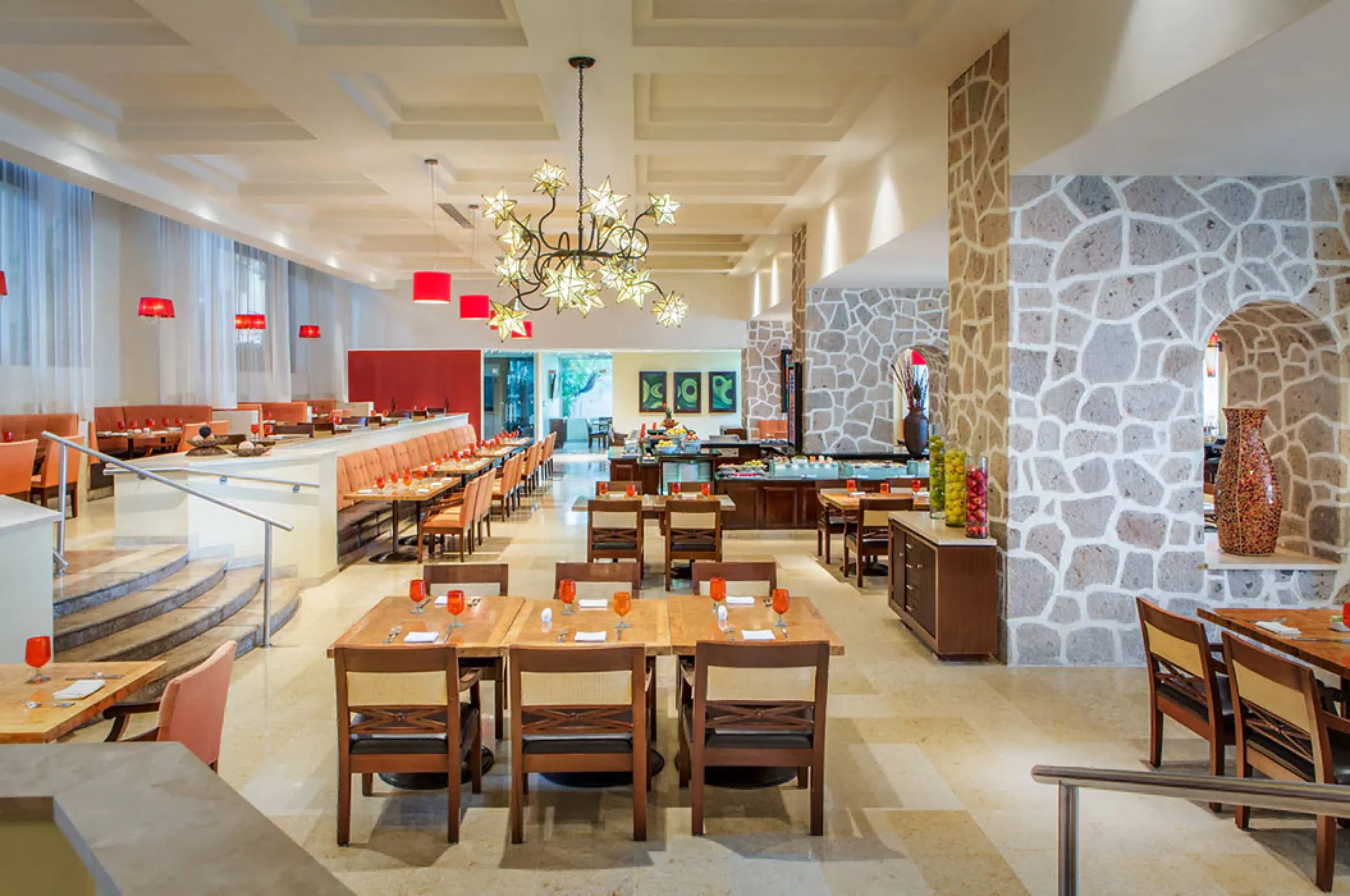 La Estancia restaurant dining room with stone walls and wooden tables at Marriott Puerto Vallarta