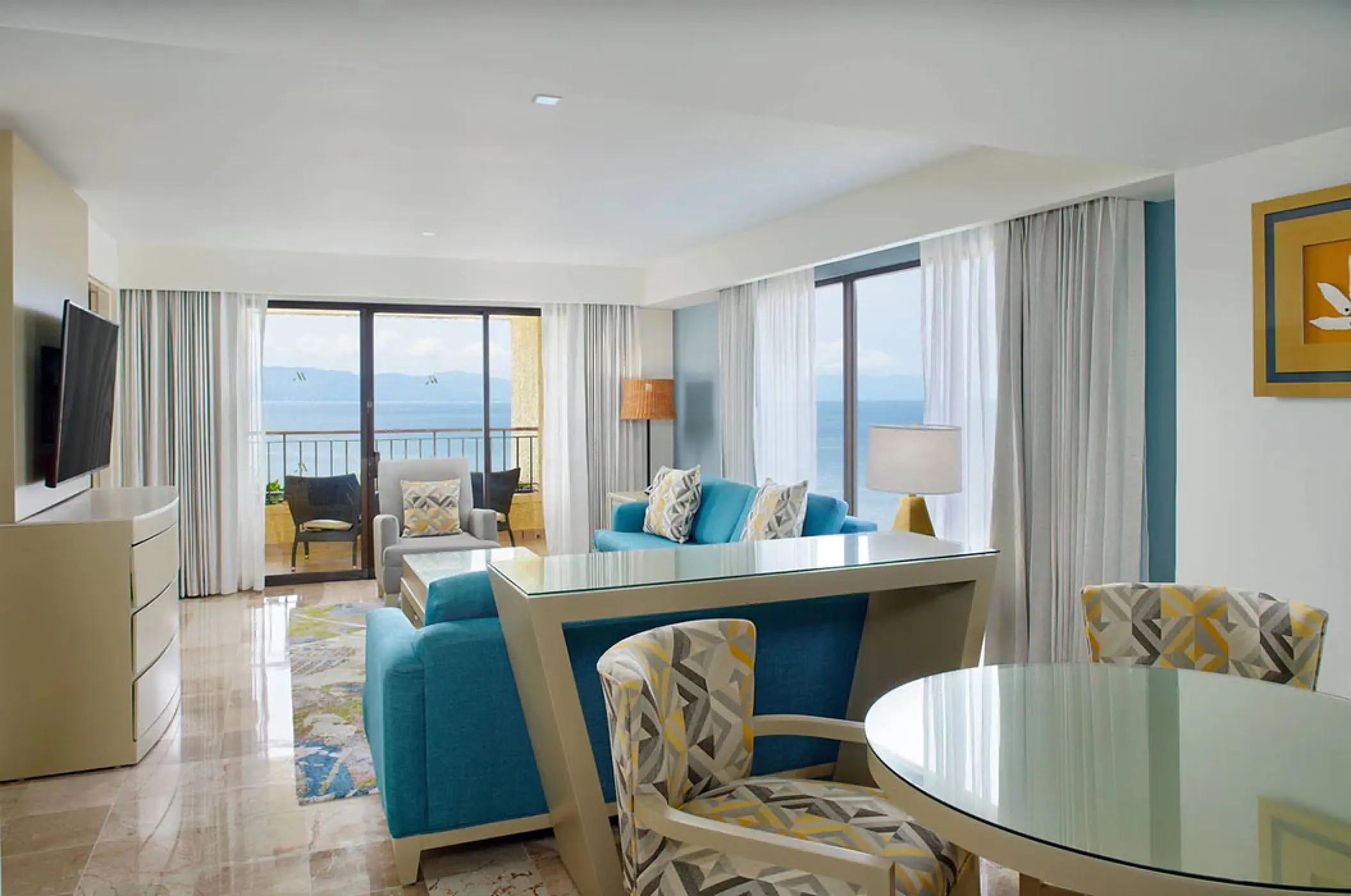 Governor Suite living area with blue sofas and balcony at Marriott Puerto Vallarta, Puerto Vallarta