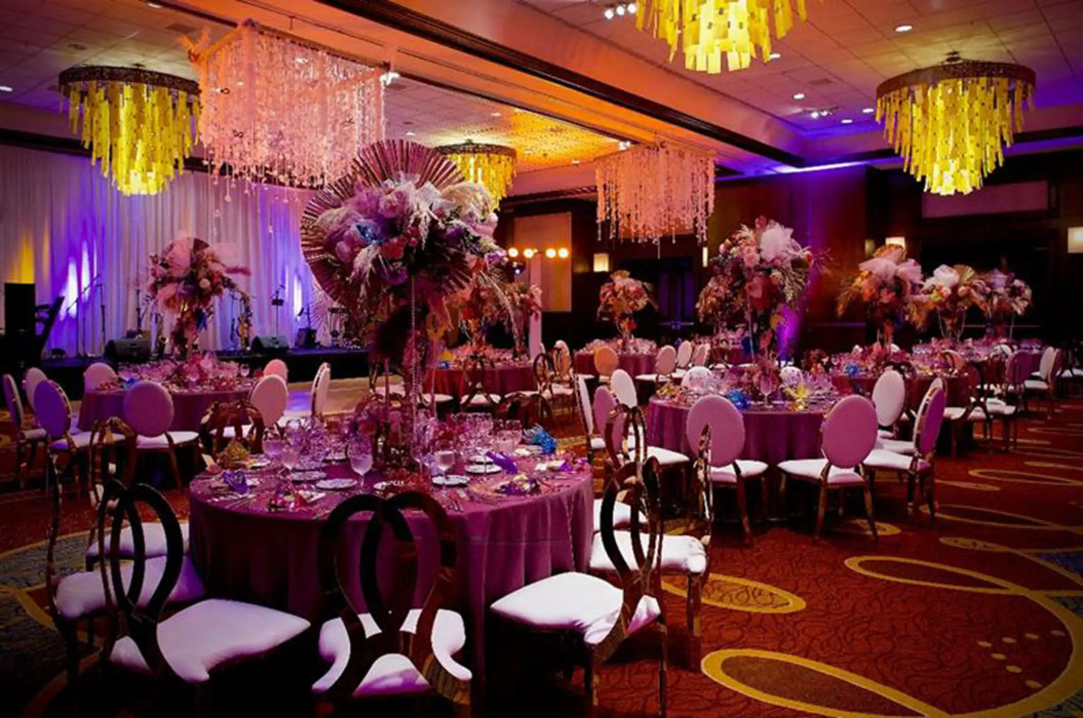 Indoor wedding reception with purple lighting and floral centerpieces at Marriott Puerto Vallarta, Puerto Vallarta