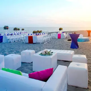 Sunset beach wedding reception with white lounge seating at Marriott Puerto Vallarta, Puerto Vallarta