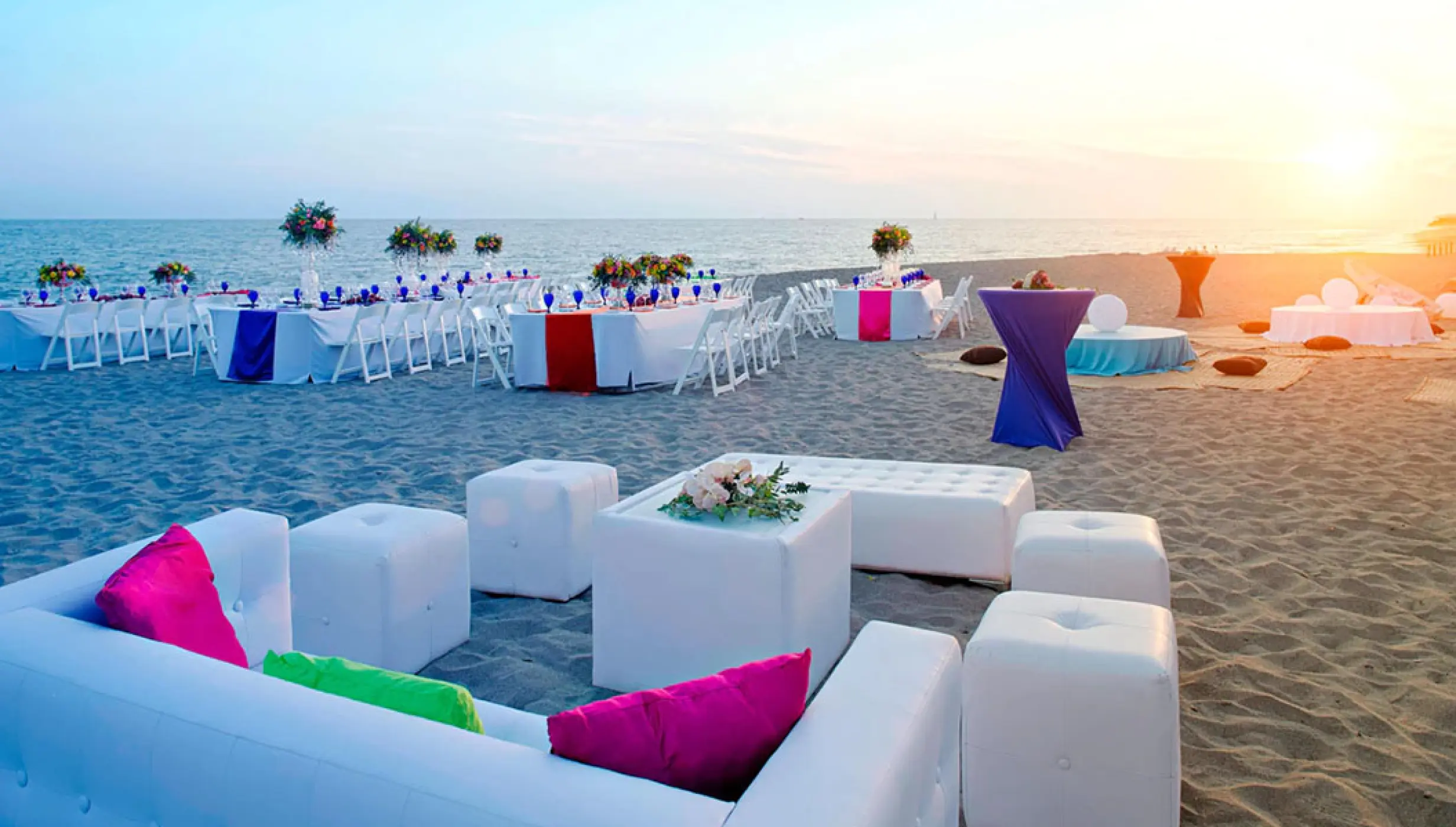 Sunset beach wedding reception with white lounge seating at Marriott Puerto Vallarta, Puerto Vallarta