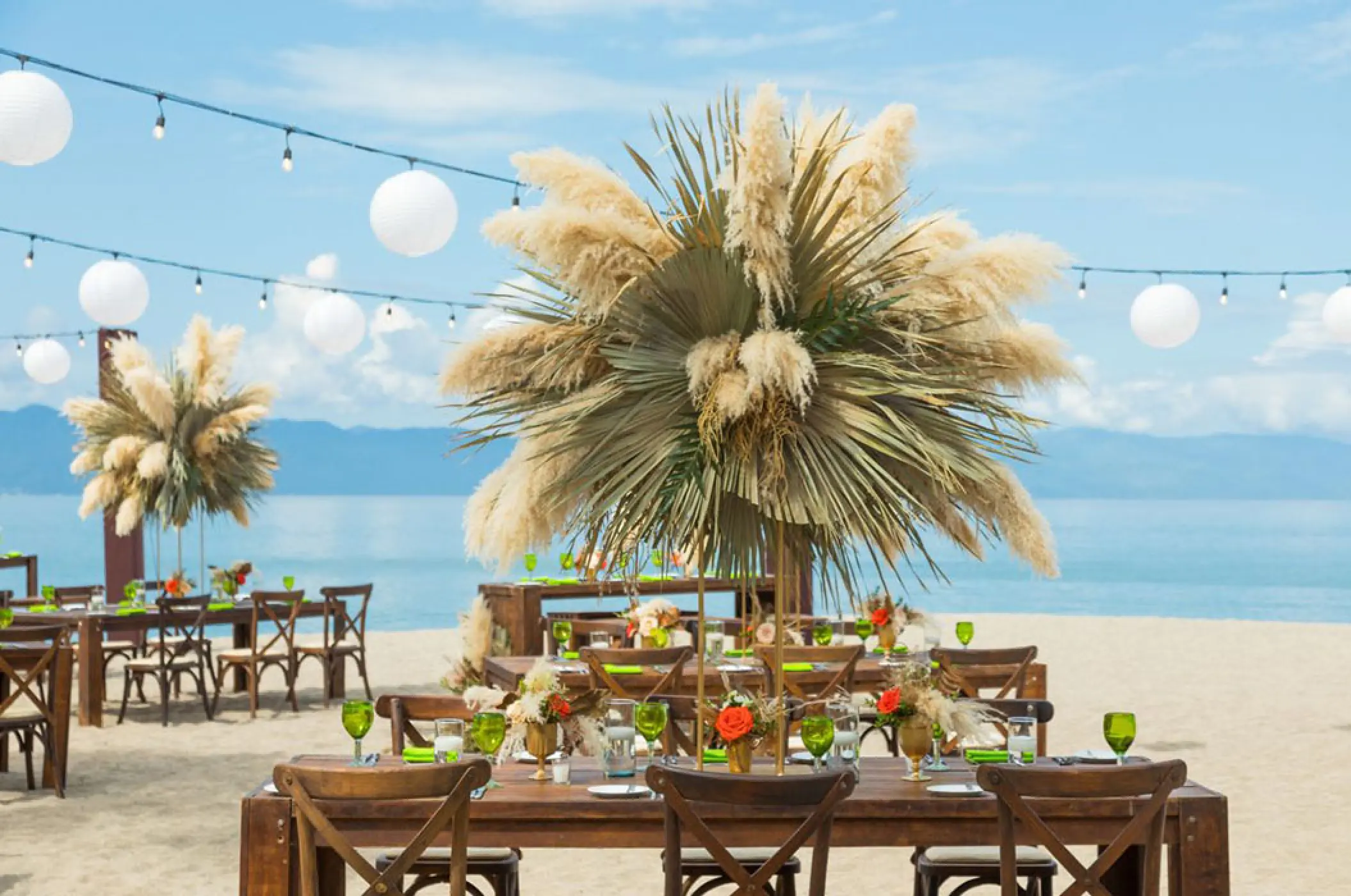 Beachfront wedding reception setup with pampas grass centerpieces at Marriott Puerto Vallarta