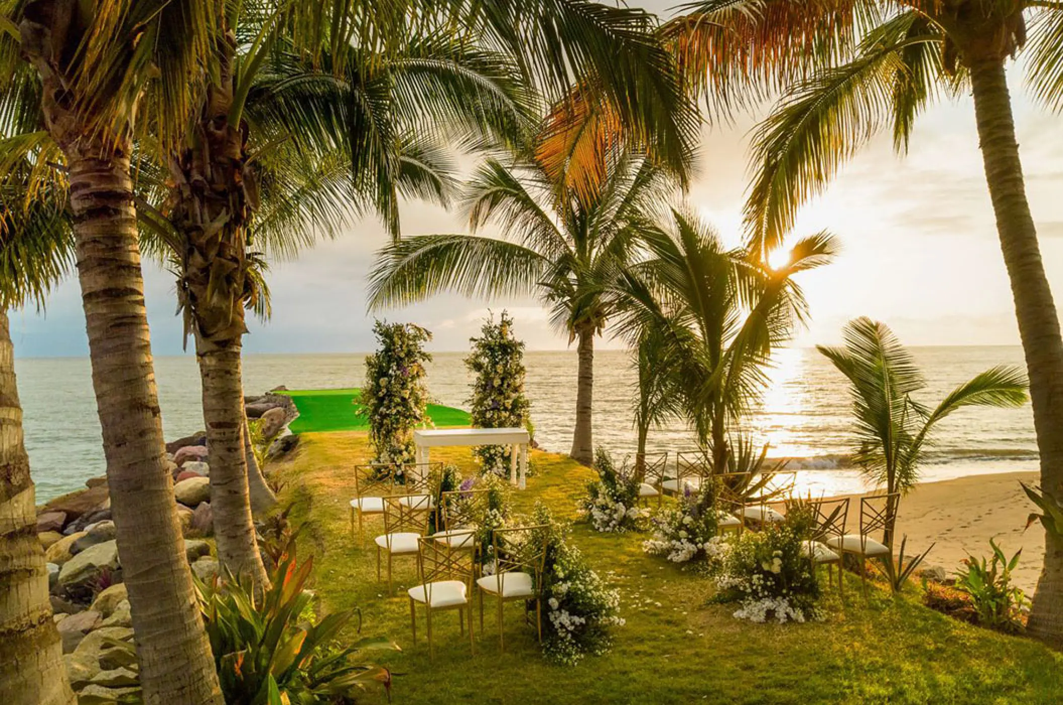 Garden wedding ceremony setup under palm trees at Marriott Puerto Vallarta, Puerto Vallarta