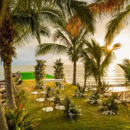 Garden wedding ceremony setup under palm trees at Marriott Puerto Vallarta, Puerto Vallarta
