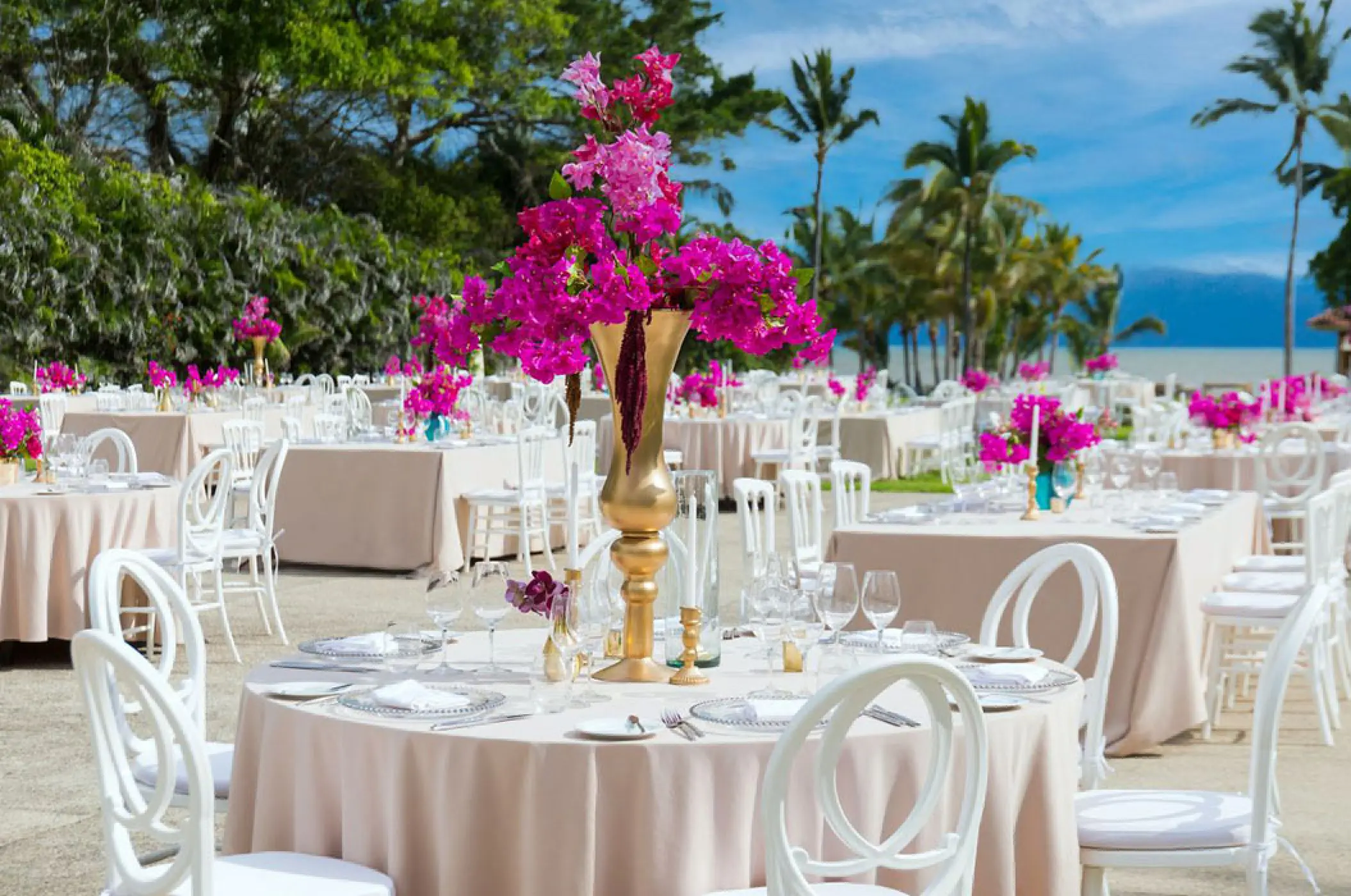 Garden wedding reception setup with pink floral centerpieces at Marriott Puerto Vallarta