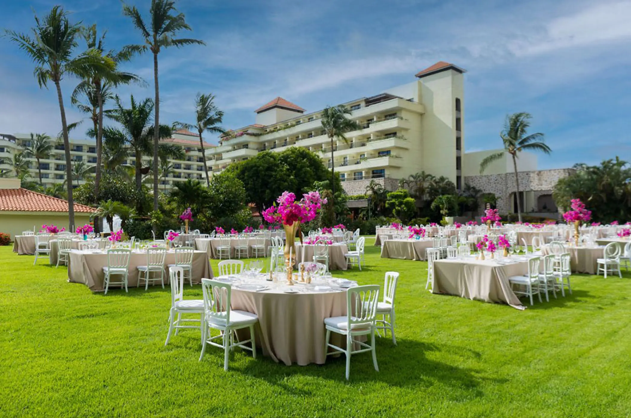 Garden wedding reception with pink floral centerpieces at Marriott Puerto Vallarta, Puerto Vallarta