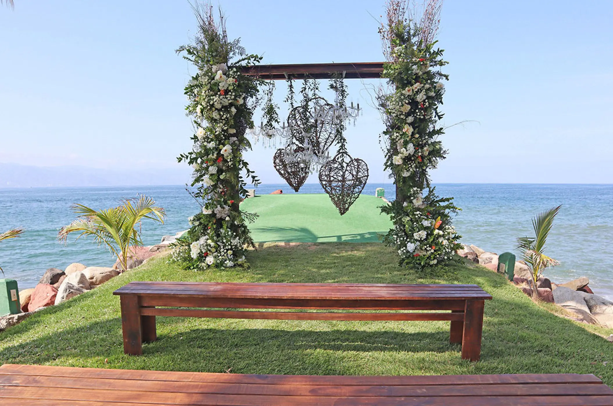 Floral jetty ceremony setup with heart-shaped lanterns at Marriott Puerto Vallarta