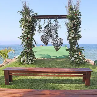 Floral jetty ceremony setup with heart-shaped lanterns at Marriott Puerto Vallarta