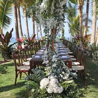 Tropical wedding reception table with white flowers and greenery at Marriott Puerto Vallarta, Puerto Vallarta