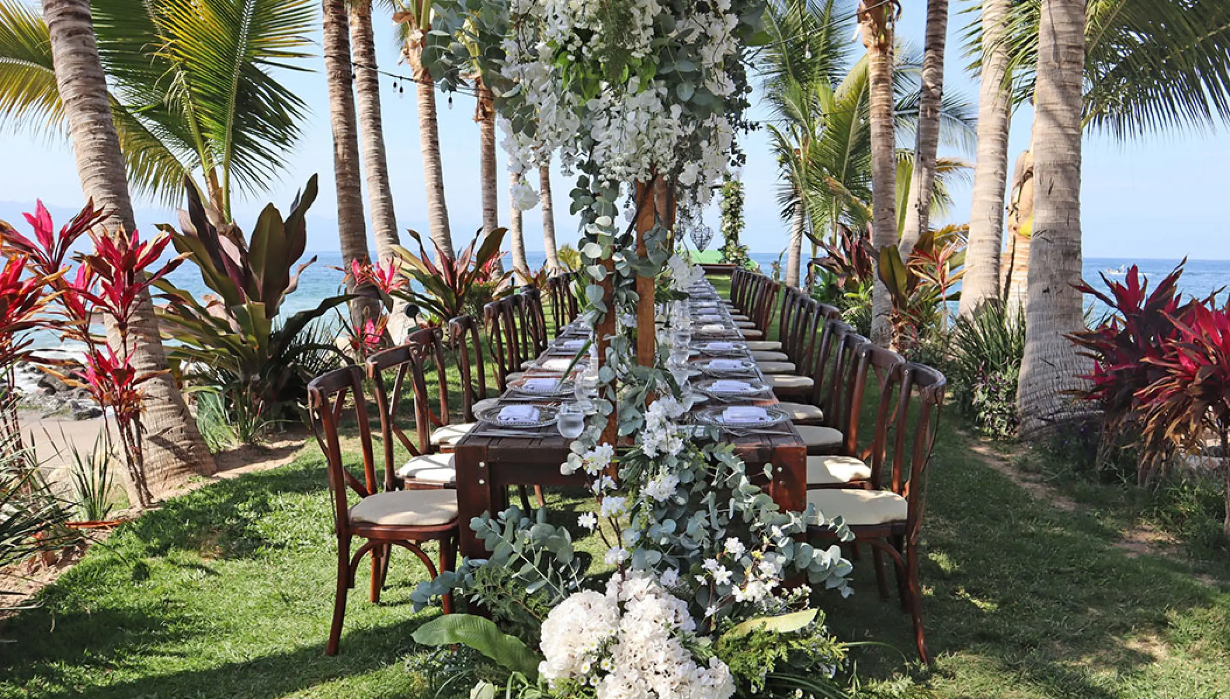Tropical wedding reception table with white flowers and greenery at Marriott Puerto Vallarta, Puerto Vallarta
