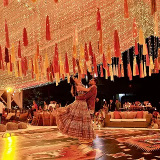 Main patio wedding reception at Marriott Puerto Vallarta under string lights and colorful tassels
