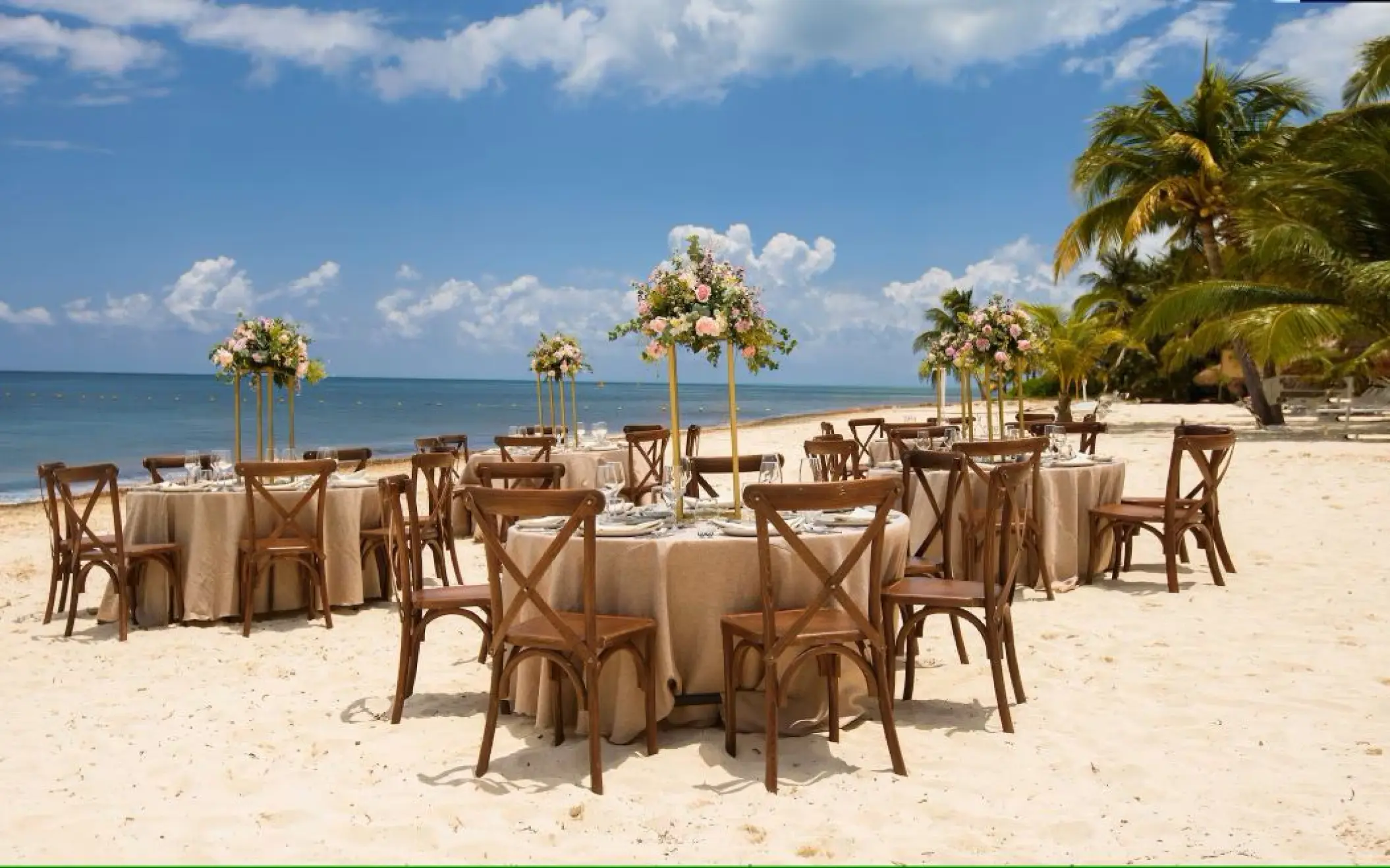 Beachfront wedding reception setup with cross-back chairs at Melia Cozumel, Cozumel
