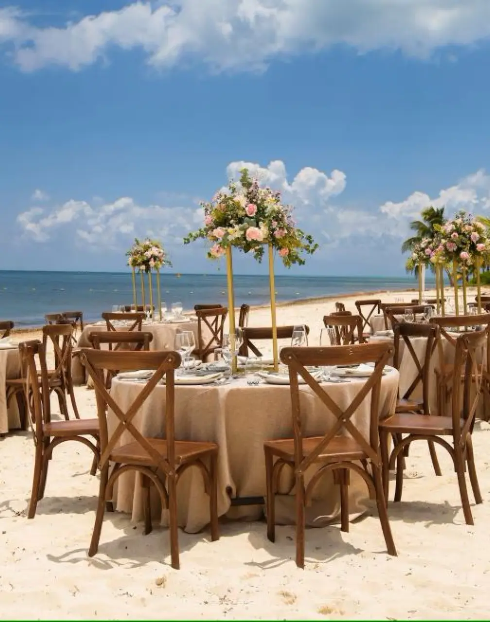 Beachfront wedding reception setup with cross-back chairs at Melia Cozumel, Cozumel
