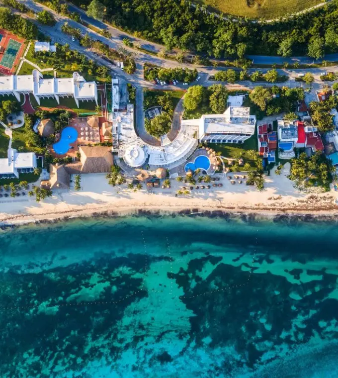 Aerial view of Melia Cozumel beachfront grounds, pools, and turquoise ocean water in Cozumel