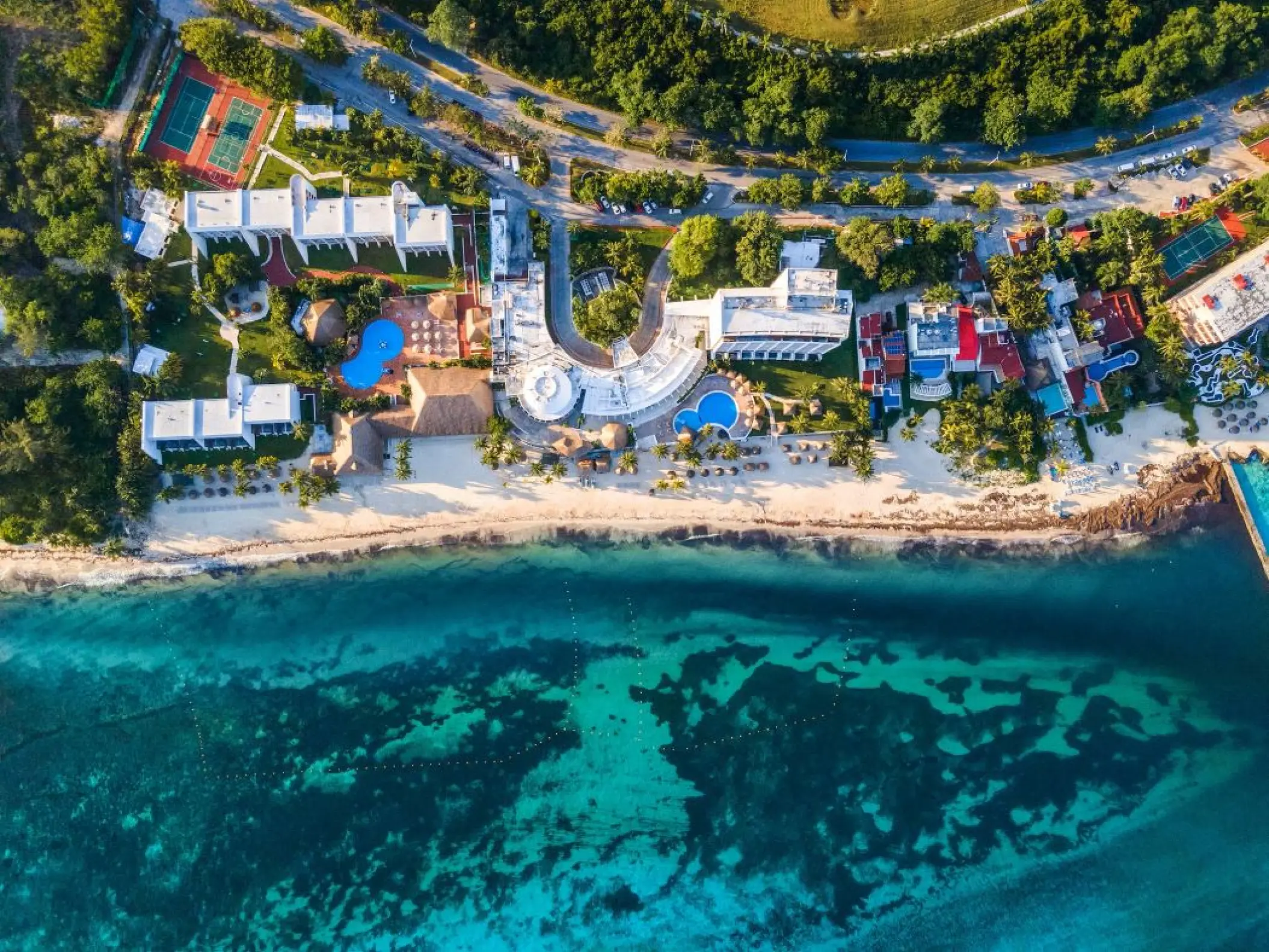 Aerial view of Melia Cozumel beachfront grounds, pools, and turquoise ocean water in Cozumel