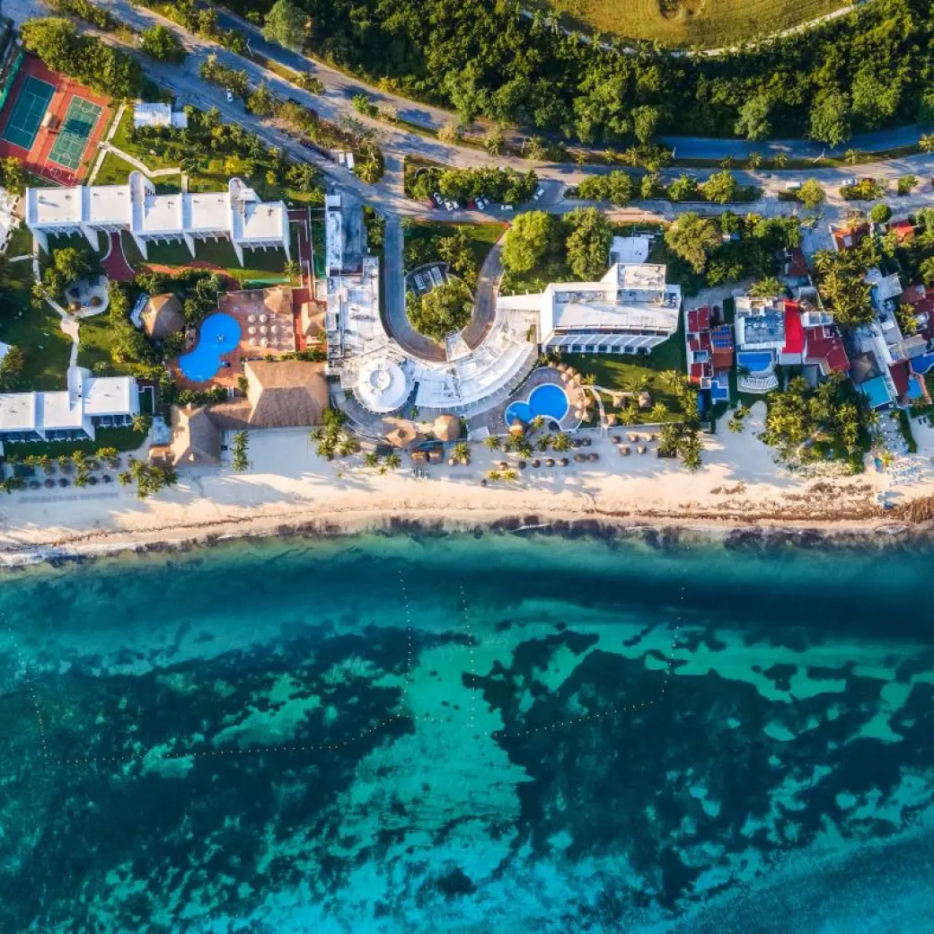 Aerial view of Melia Cozumel beachfront grounds, pools, and turquoise ocean water in Cozumel