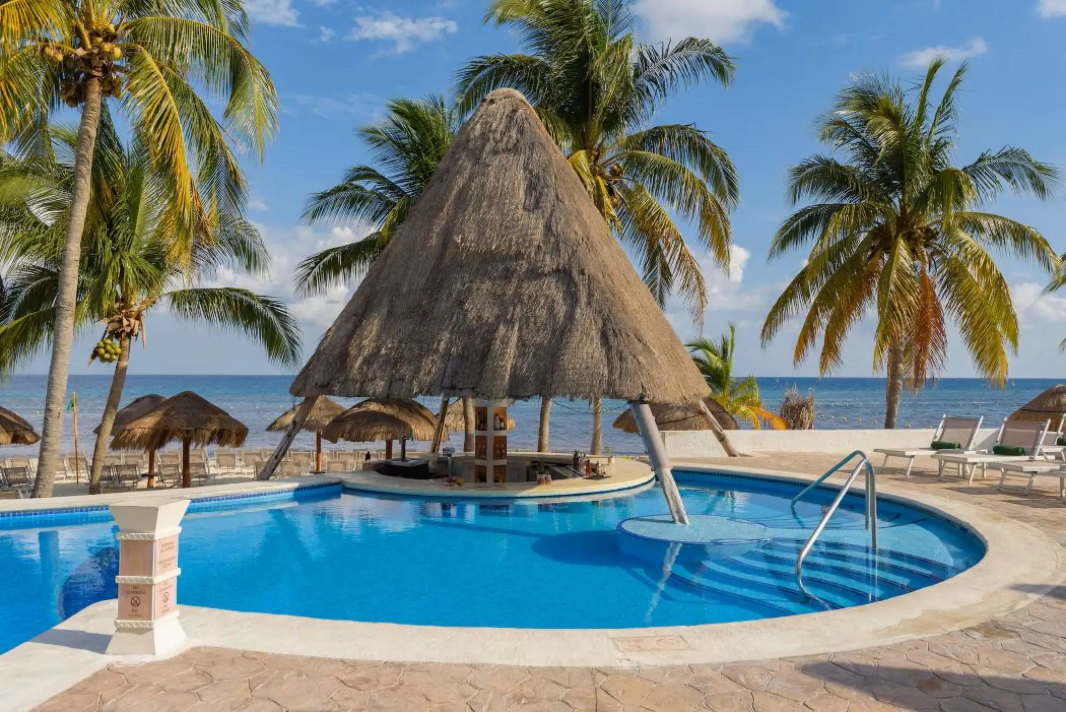 Swim-up bar with thatched roof at the Melia Cozumel pool, Cozumel