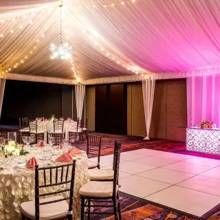 Indoor ballroom wedding reception with white dance floor and pink lighting at Moon Palace Jamaica, Ocho Rios