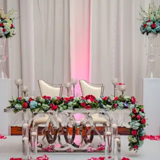 Ballroom wedding reception sweetheart table with red and blue flowers at Moon Palace Jamaica, Ocho Rios
