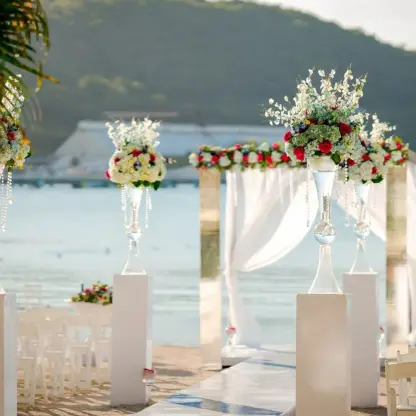 Beachfront wedding ceremony with white floral arch at Moon Palace Jamaica, Ocho Rios