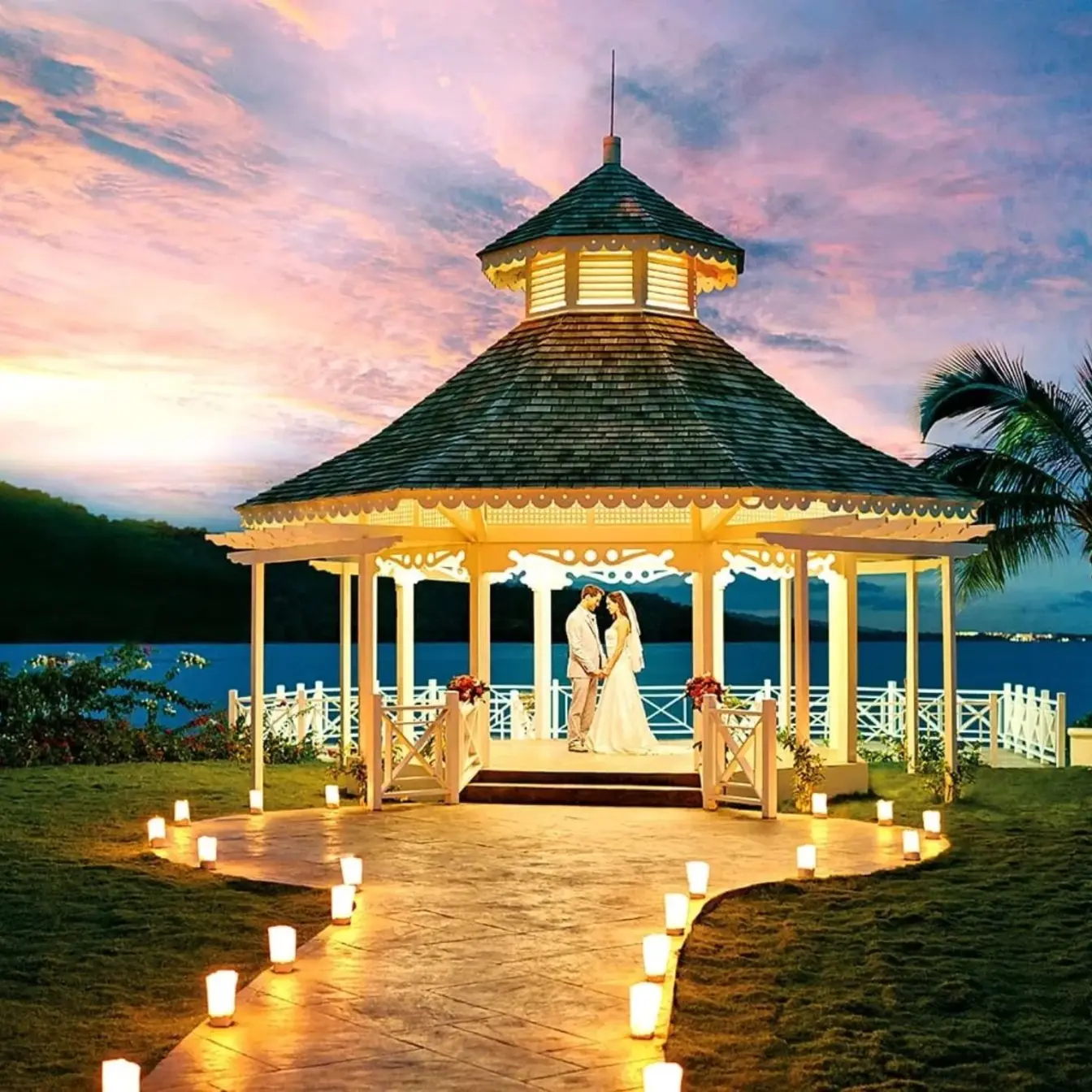 The bride and groom standing in the North Gazebo at sunset at Moon Palace Jamaica, Ocho Rios