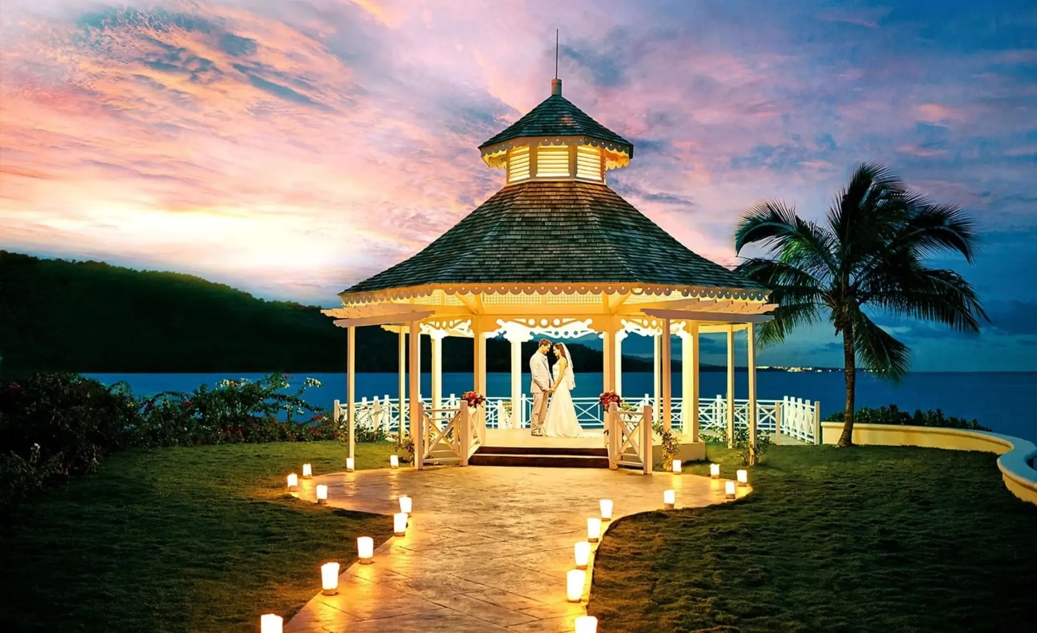 The bride and groom standing in the North Gazebo at sunset at Moon Palace Jamaica, Ocho Rios