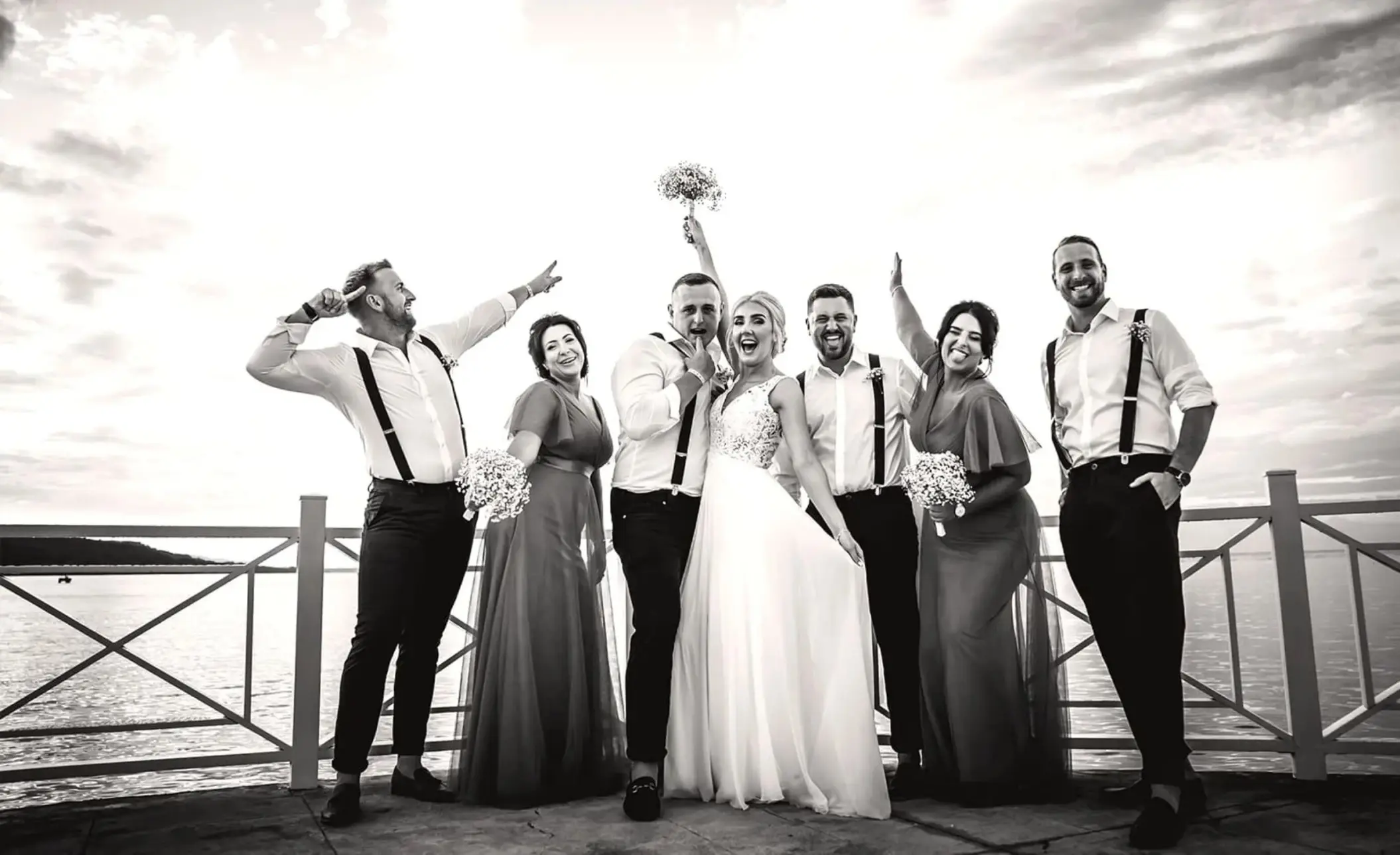 Bride and groom celebrating with their wedding party on a pier at Moon Palace Jamaica, Ocho Rios