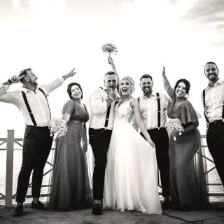 Bride and groom celebrating with their wedding party on a pier at Moon Palace Jamaica, Ocho Rios