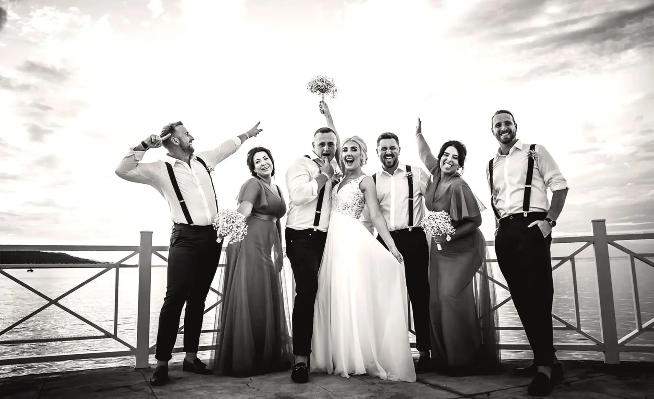 Bride and groom celebrating with their wedding party on a pier at Moon Palace Jamaica, Ocho Rios
