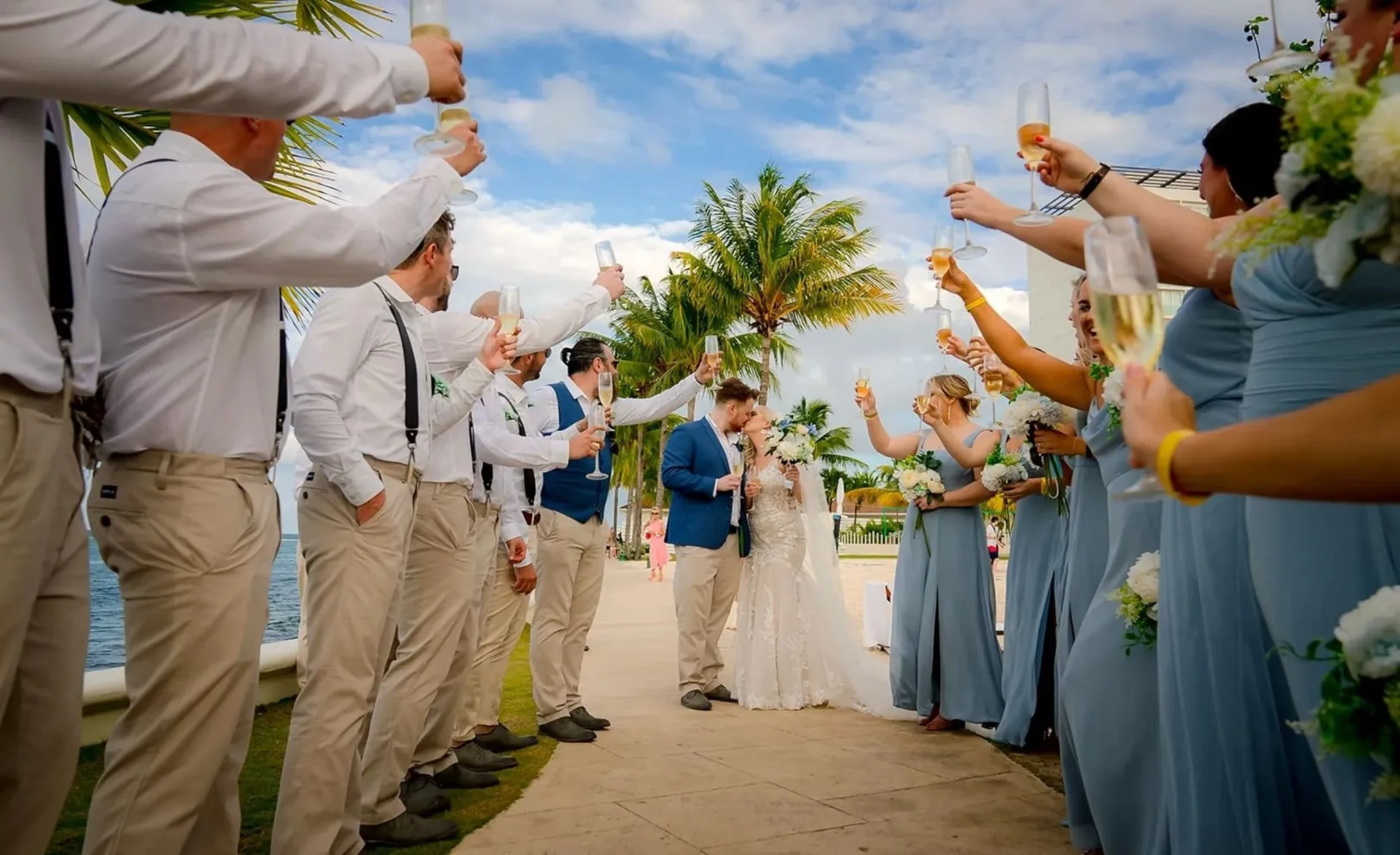 bride and groom kiss as the guests cheer them on at Moon Palace Jamaica