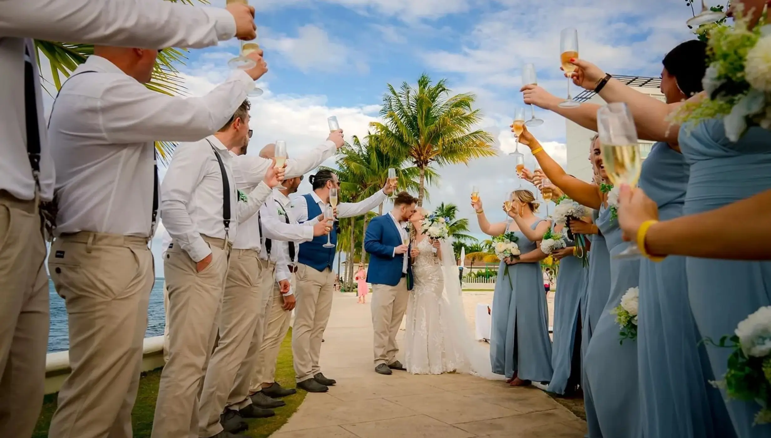 bride and groom kiss as the guests cheer them on at Moon Palace Jamaica