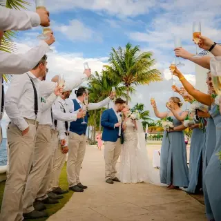 Bride and groom kiss as guests toast them at Moon Palace Jamaica