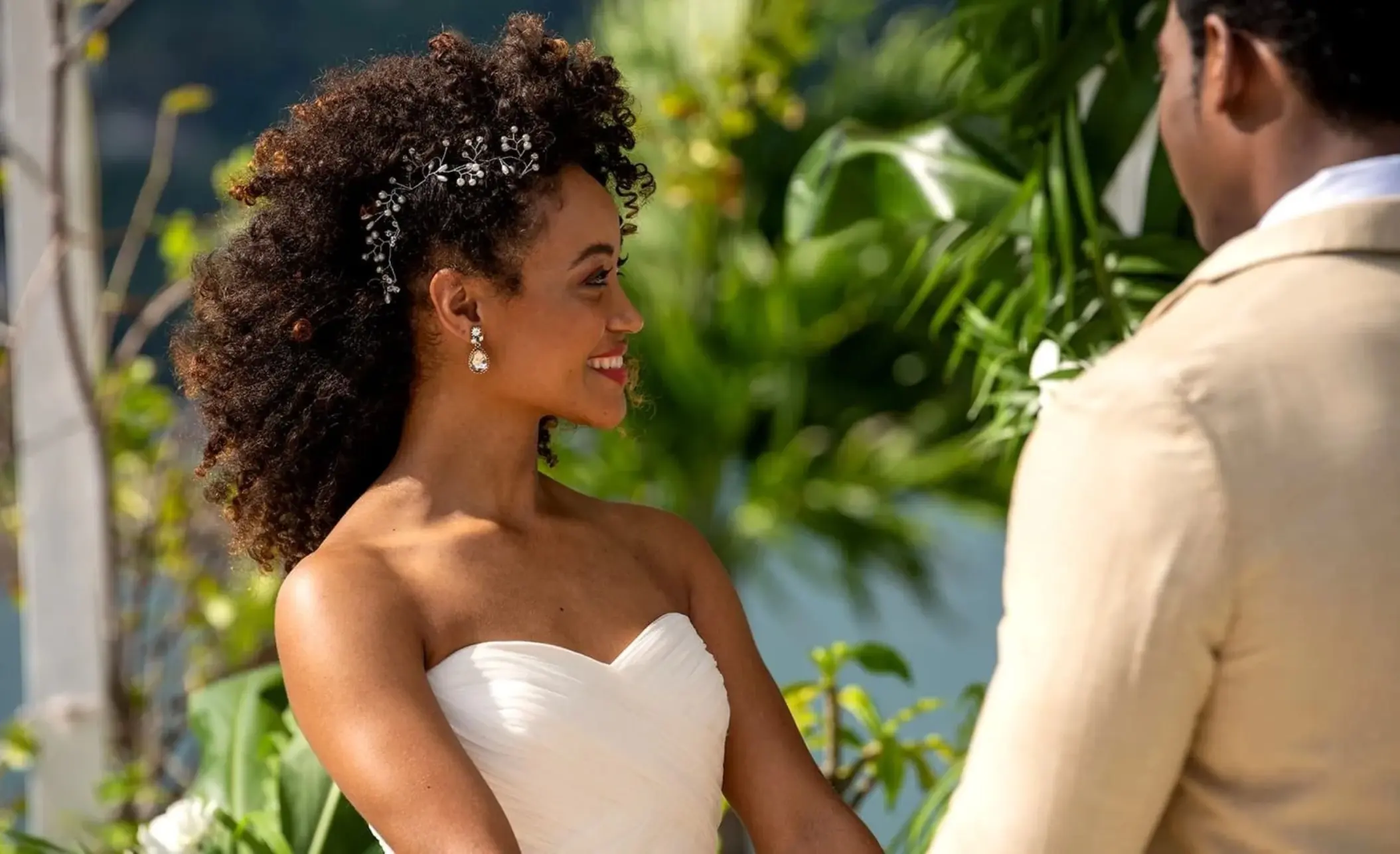Smiling bride looking at the groom during their wedding ceremony at Moon Palace Jamaica, Ocho Rios