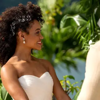 Smiling bride looking at the groom during their wedding ceremony at Moon Palace Jamaica, Ocho Rios