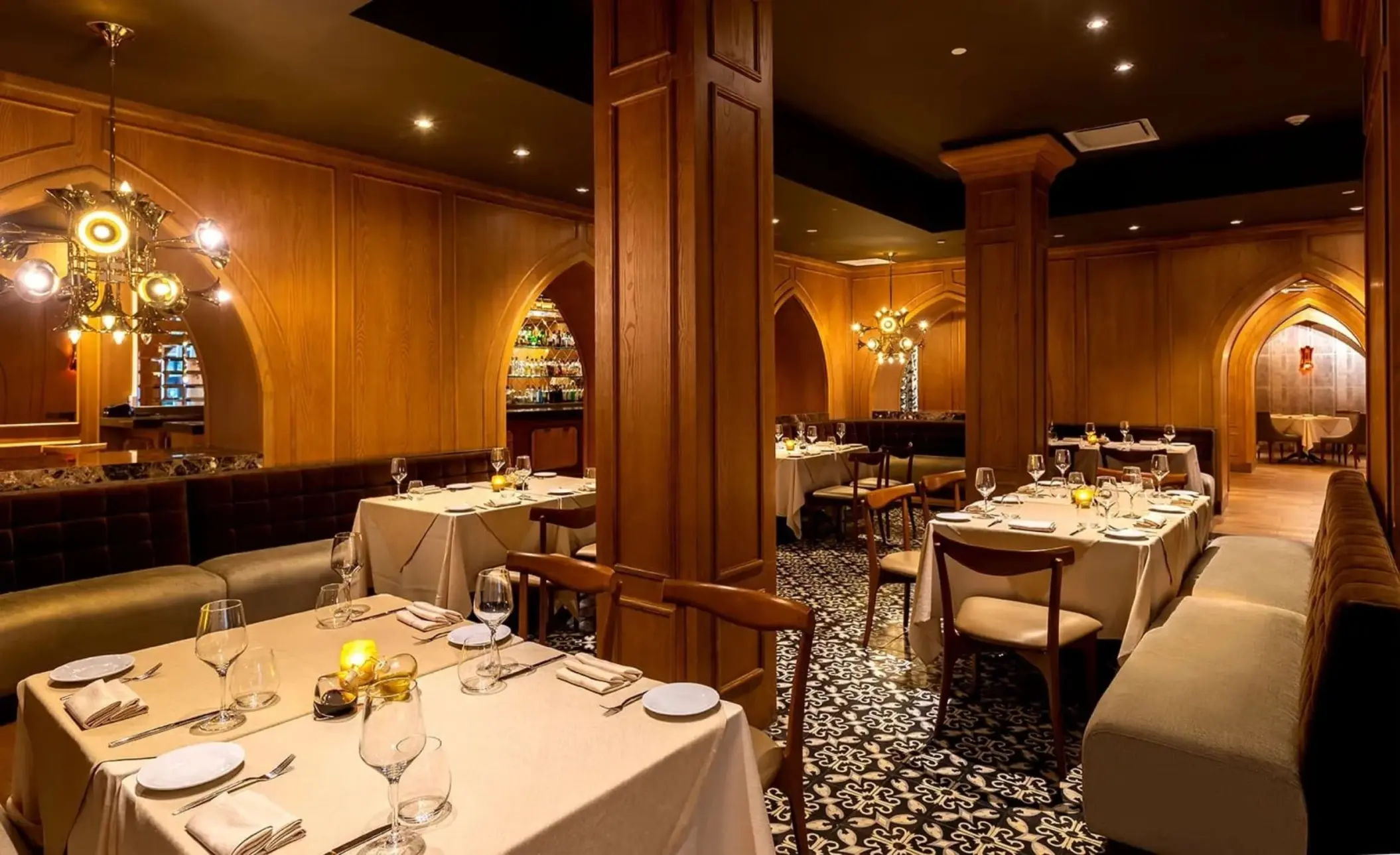 Elegant indoor restaurant with wood-paneled walls and patterned tile floors at Moon Palace Jamaica, Ocho Rios