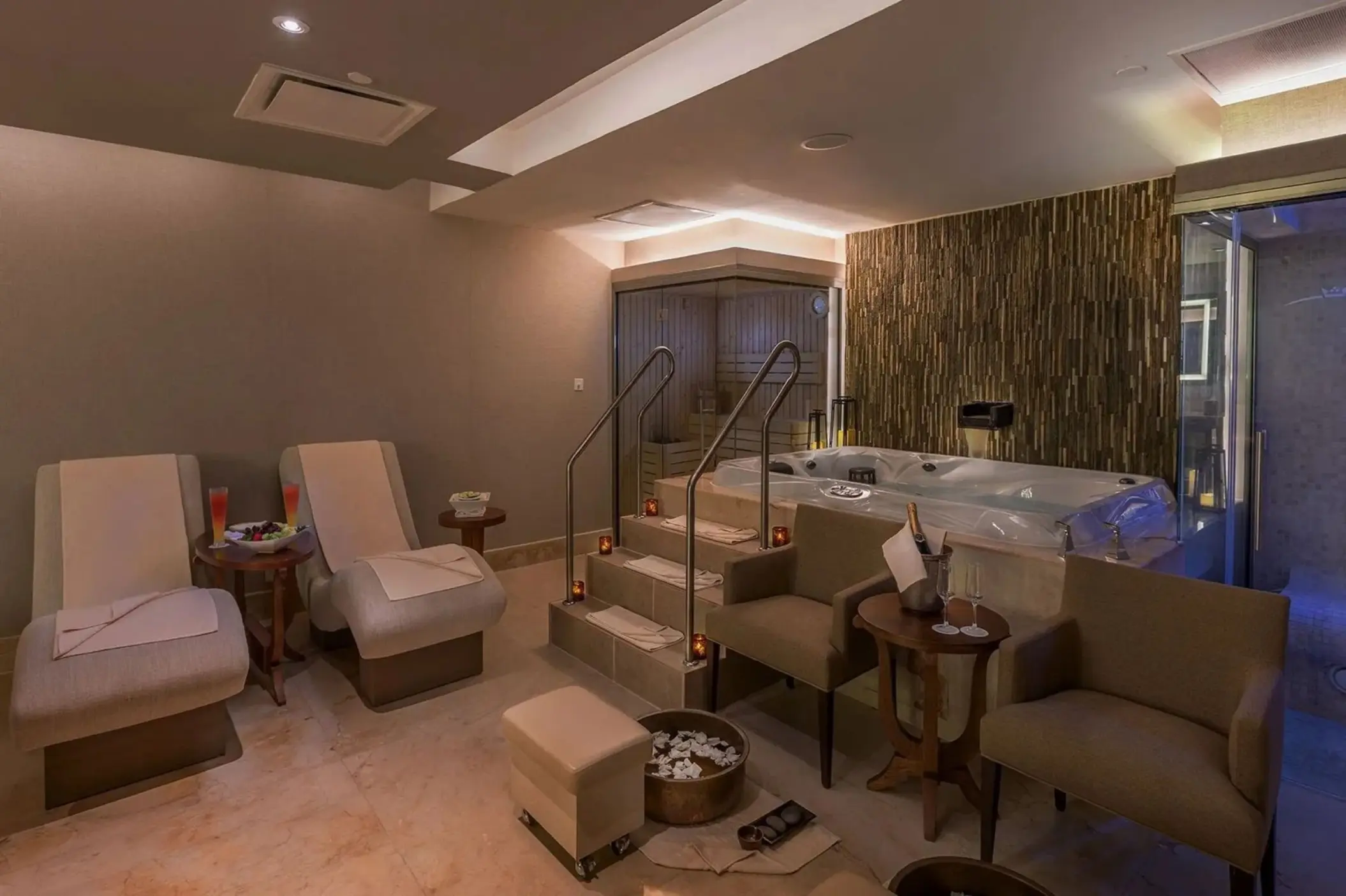 Private VIP spa suite with a whirlpool, lounge chairs, and pedicure bowls at Moon Palace Jamaica, Ocho Rios