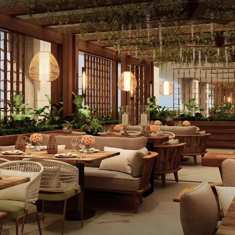 Carvao restaurant interior with wooden tables and woven light fixtures at Moon Palace Punta Cana