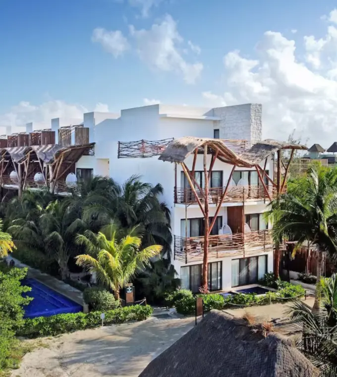 Aerial view of the white buildings and tropical grounds at Mystique Holbox by Royalton, Isla Holbox