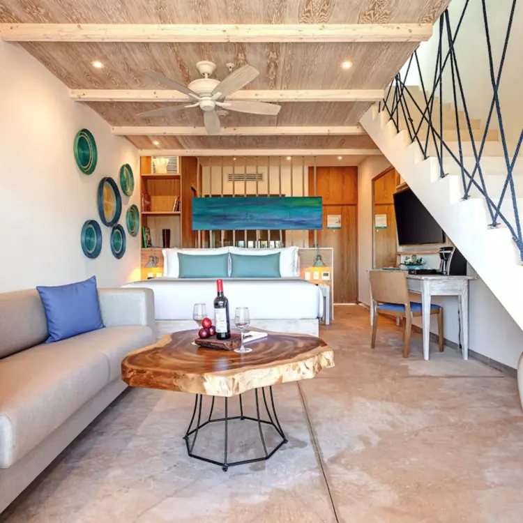 Deluxe Junior Suite Loft with wood accents and nautical rope decor at Mystique Holbox, Isla Holbox