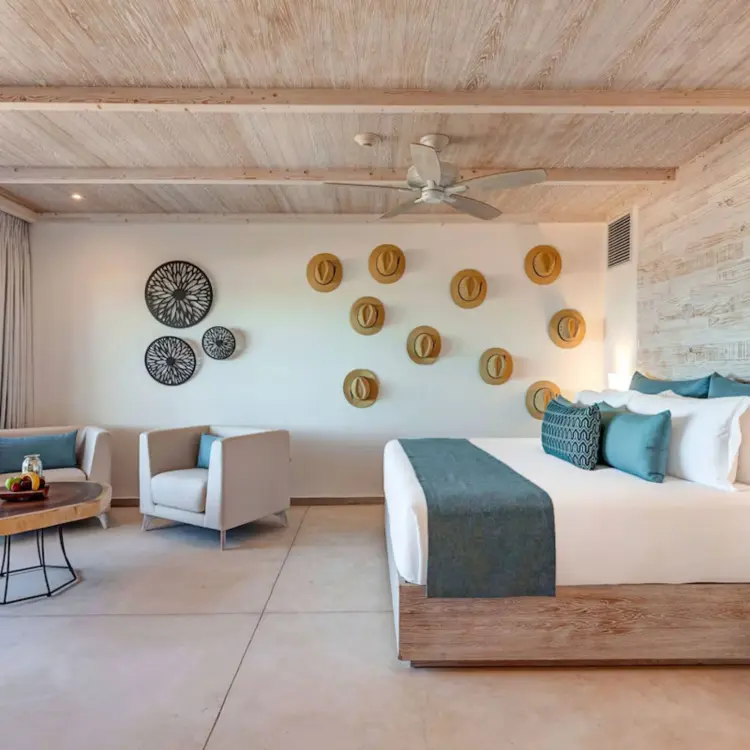 Suite with king bed, wooden accents, and ocean views at Mystique Holbox, Isla Holbox