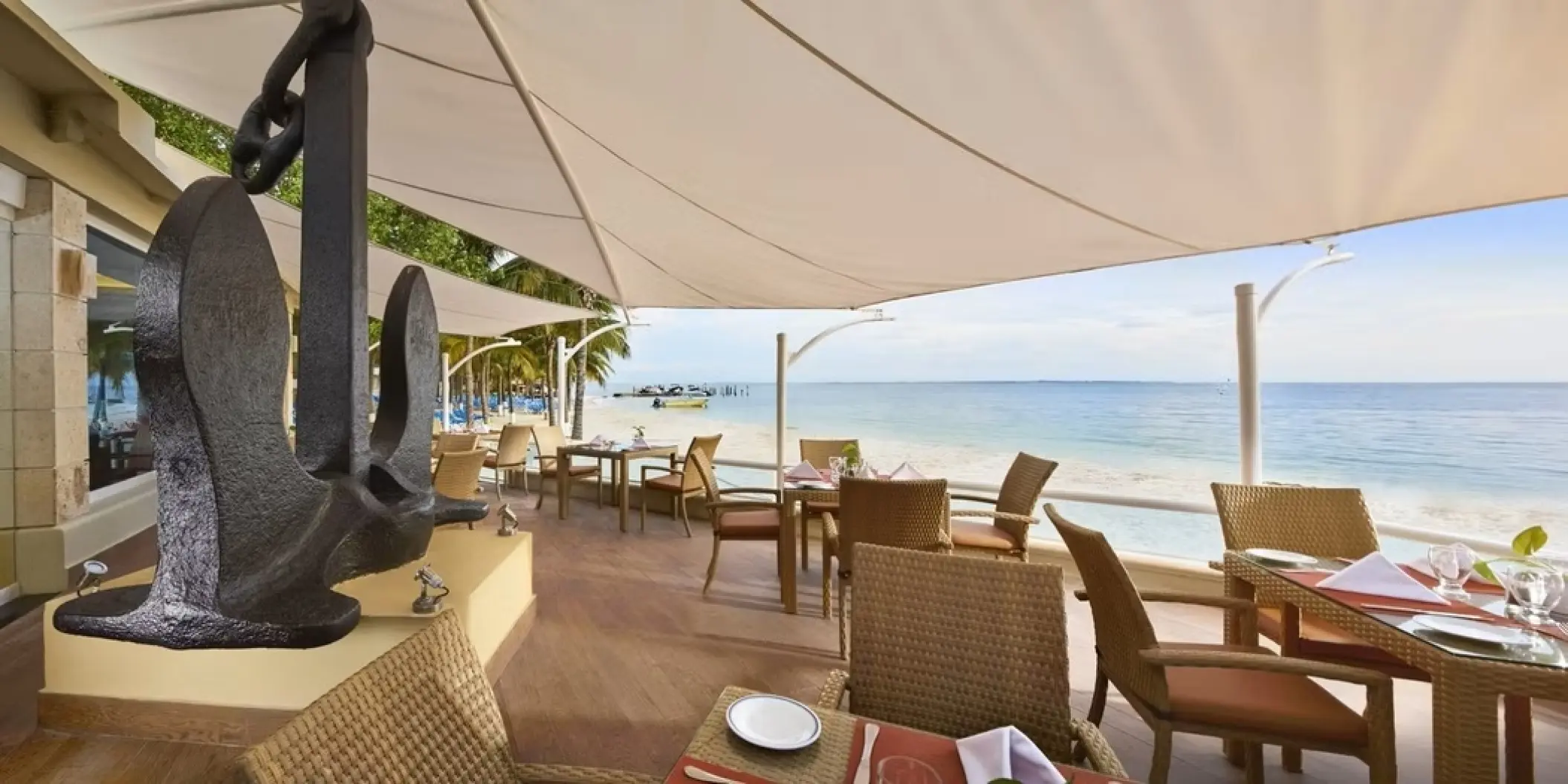 Beachfront restaurant with a large anchor sculpture at Occidental Costa Cancun, Cancun