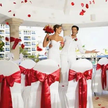 Bride and groom under a gazebo with falling rose petals at Occidental Costa Cancun