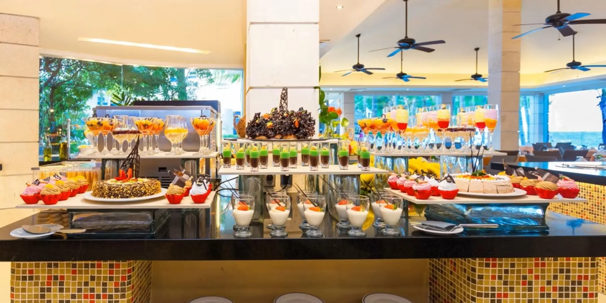 Buffet dessert station with cakes, pastries and parfaits at Occidental Costa Cancun